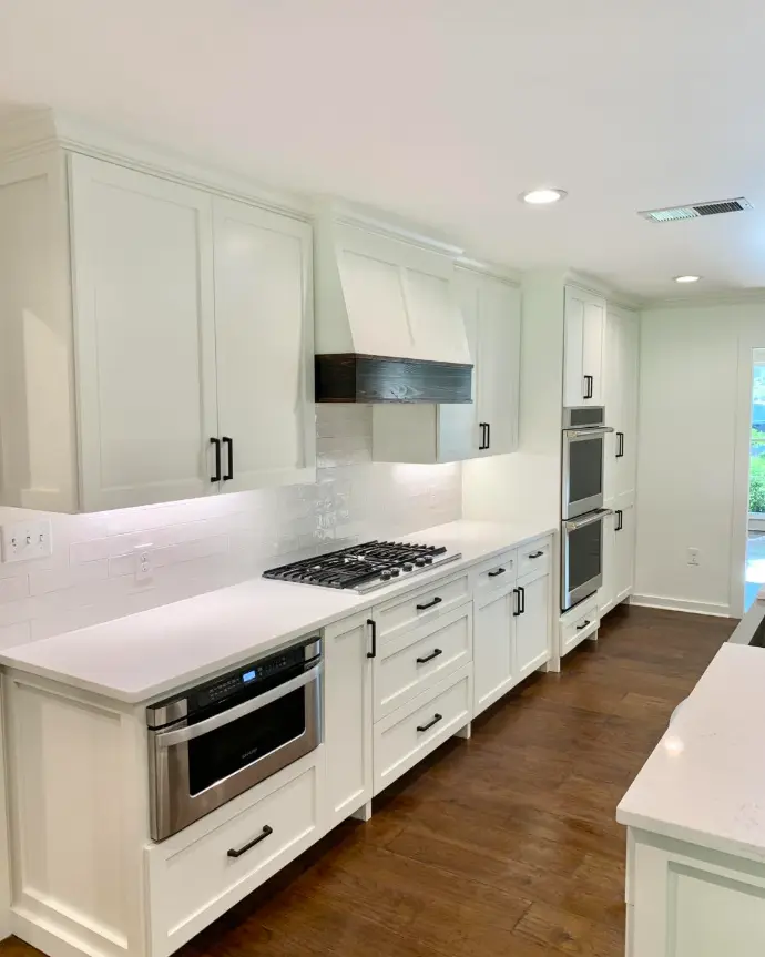 White kitchen with a concealed hood and wall oven